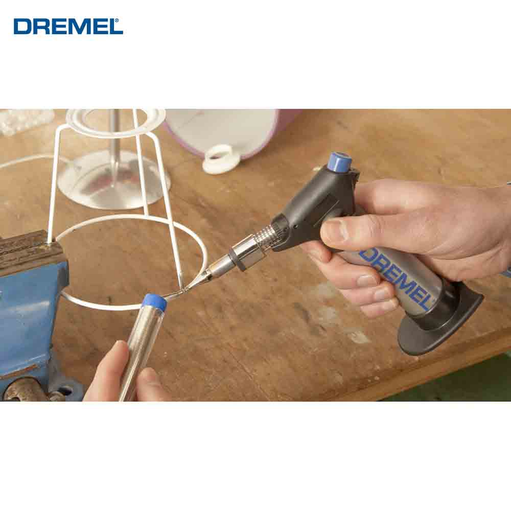 Dremel tool being used on a wooden surface with a white background