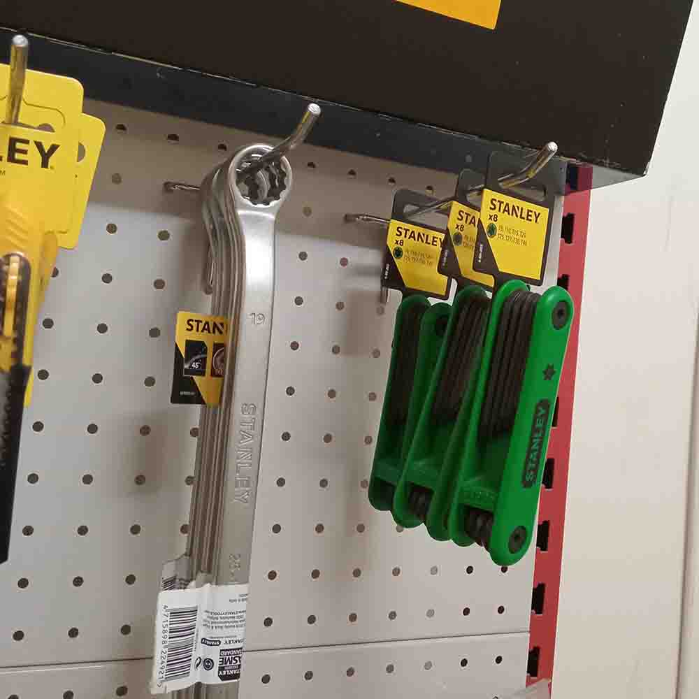 Stanley tools including wrenches and pliers on a pegboard.